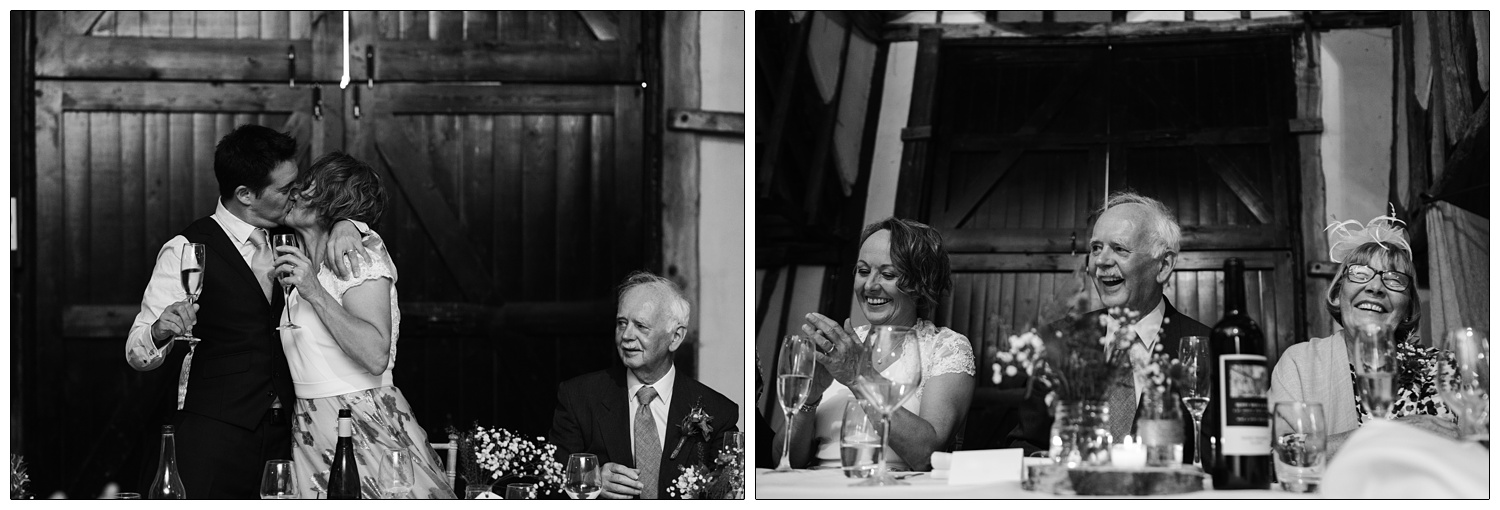 Bride and groom kiss during speeches.