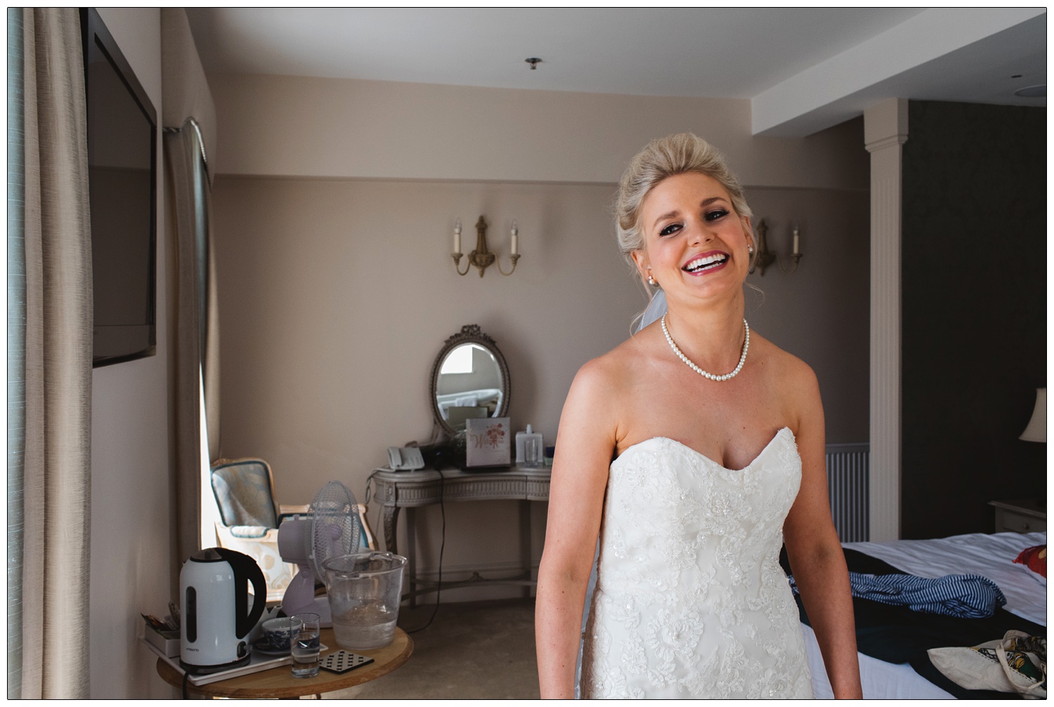 Bride laughing in the bedroom at Mill Hotel.