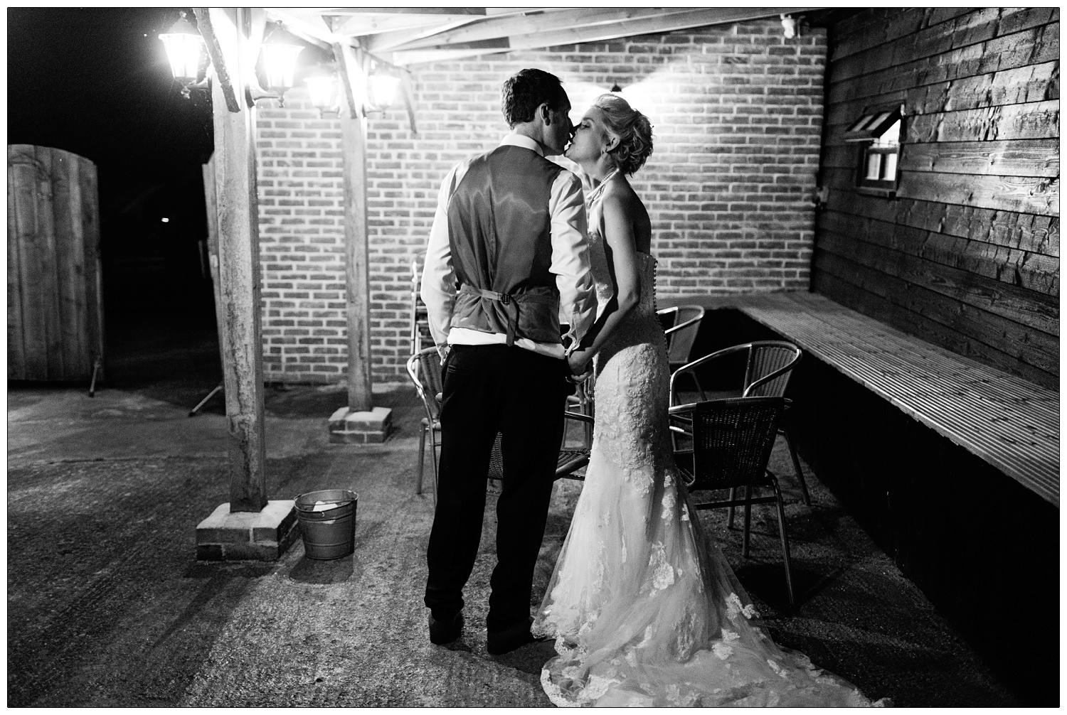 bride and groom kissing outside in the courtyard at Alpheton Hall Barns.