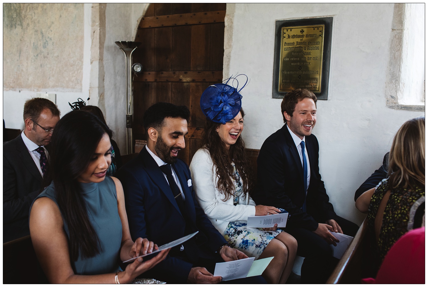 Guests laughing and waiting for wedding to start