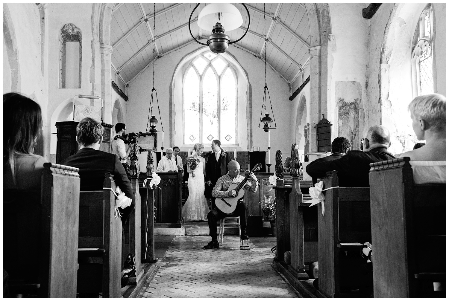 Man playing guitar in the church in Alpheton.