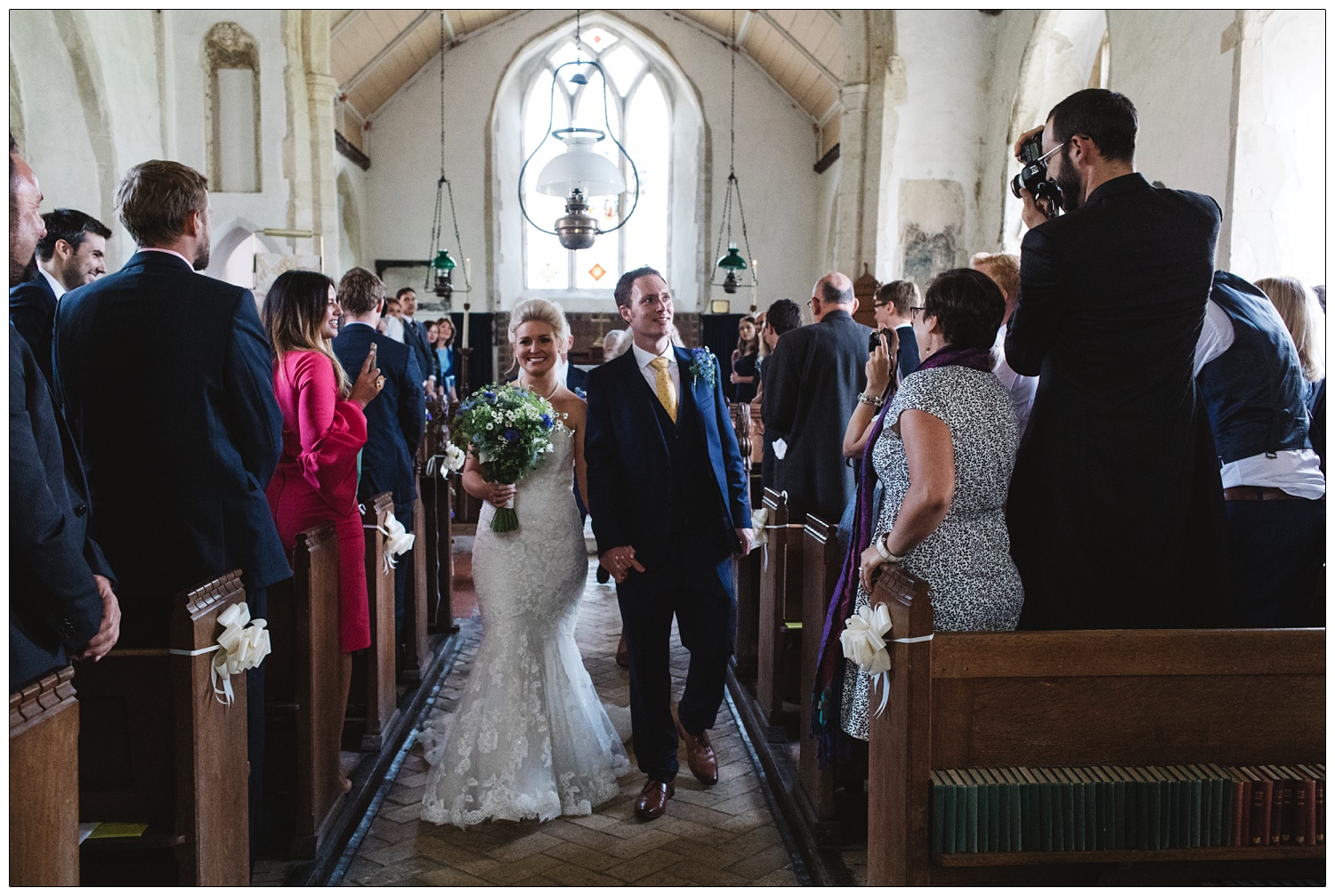 Newly married couple walking down the aisle.