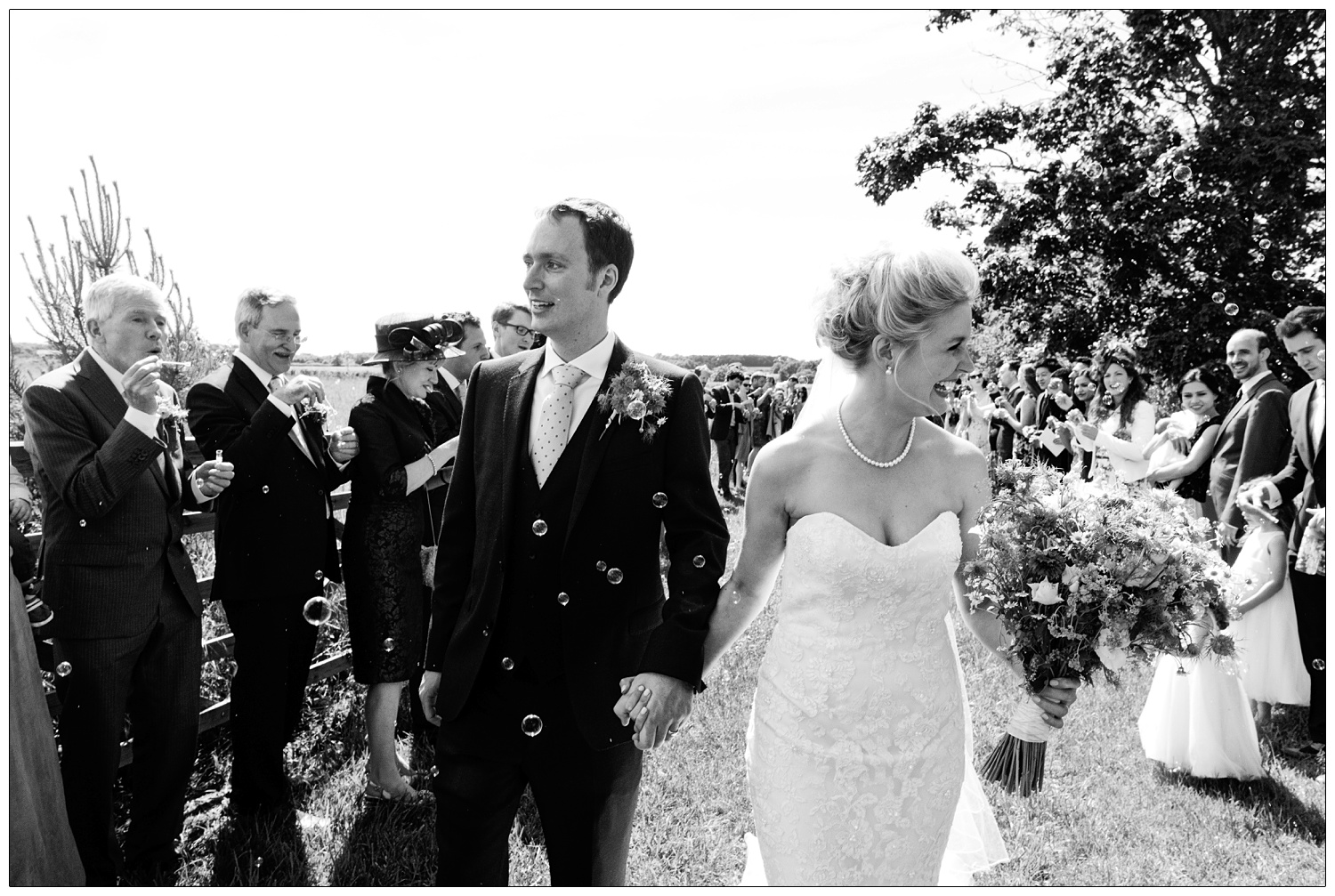 Bride and groom walking through bubbles