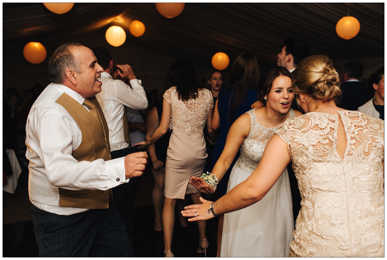 Bride dancing with her sister and dad.