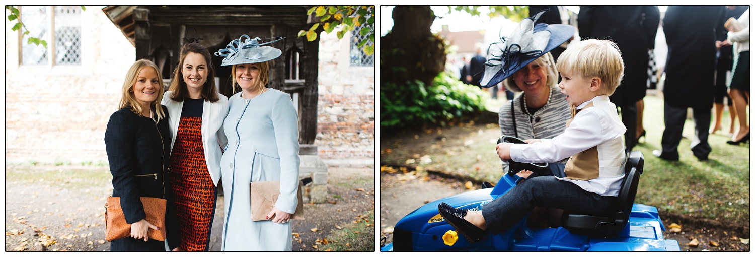 Three women standing outside a church. A boy riding a blue toy New Holland tractor.