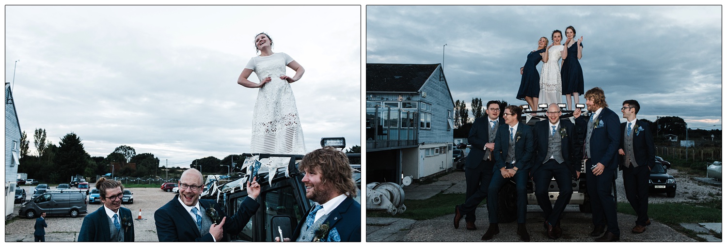 Bride and bridesmaids standing on top of her Land Rover. The groom and his groomsmen are leaning on the front.