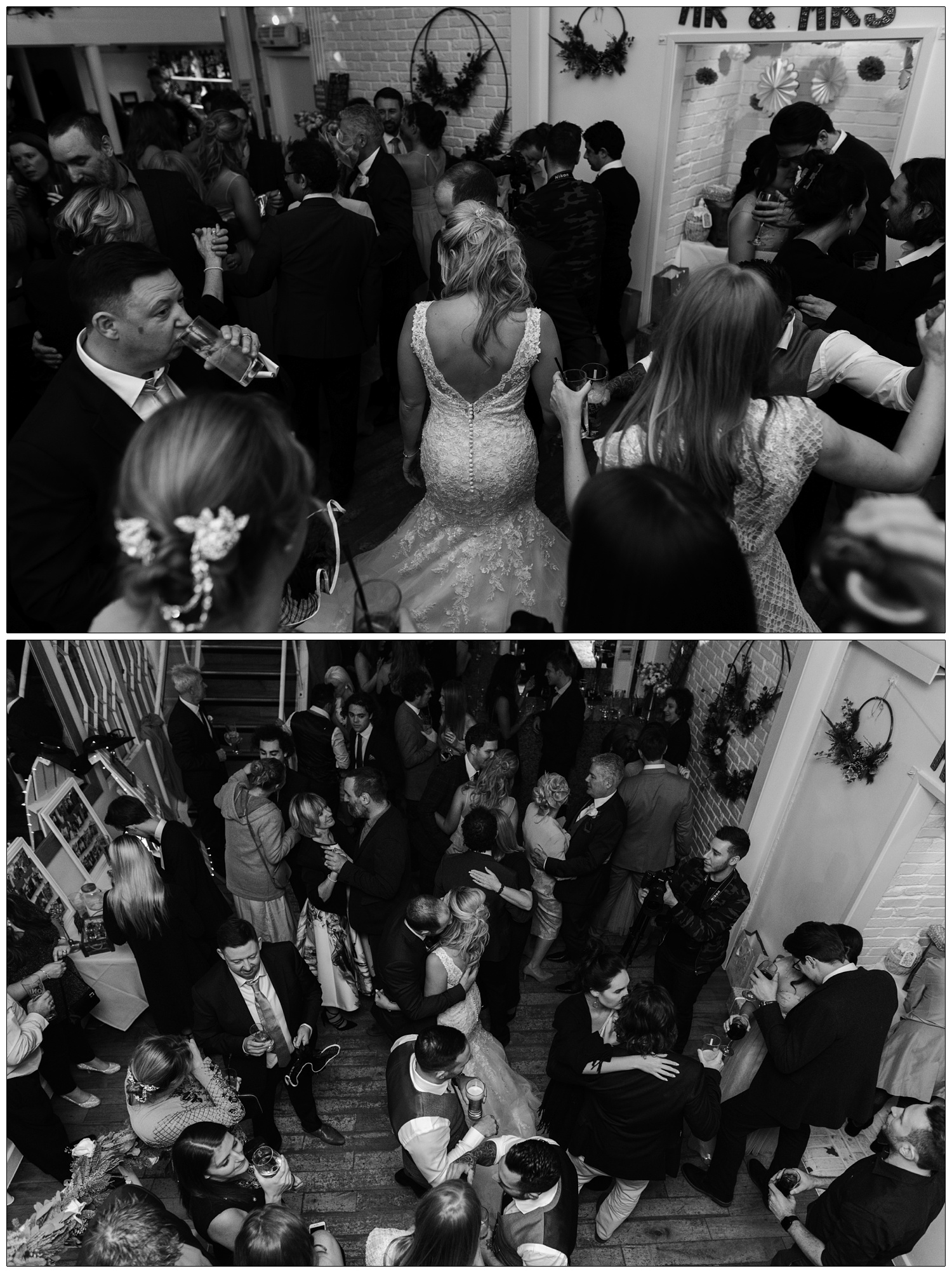 Black and white photograph from above of people dancing at a wedding reception in Rayleigh. The bride and groom are in the middle, surrounded by guests.