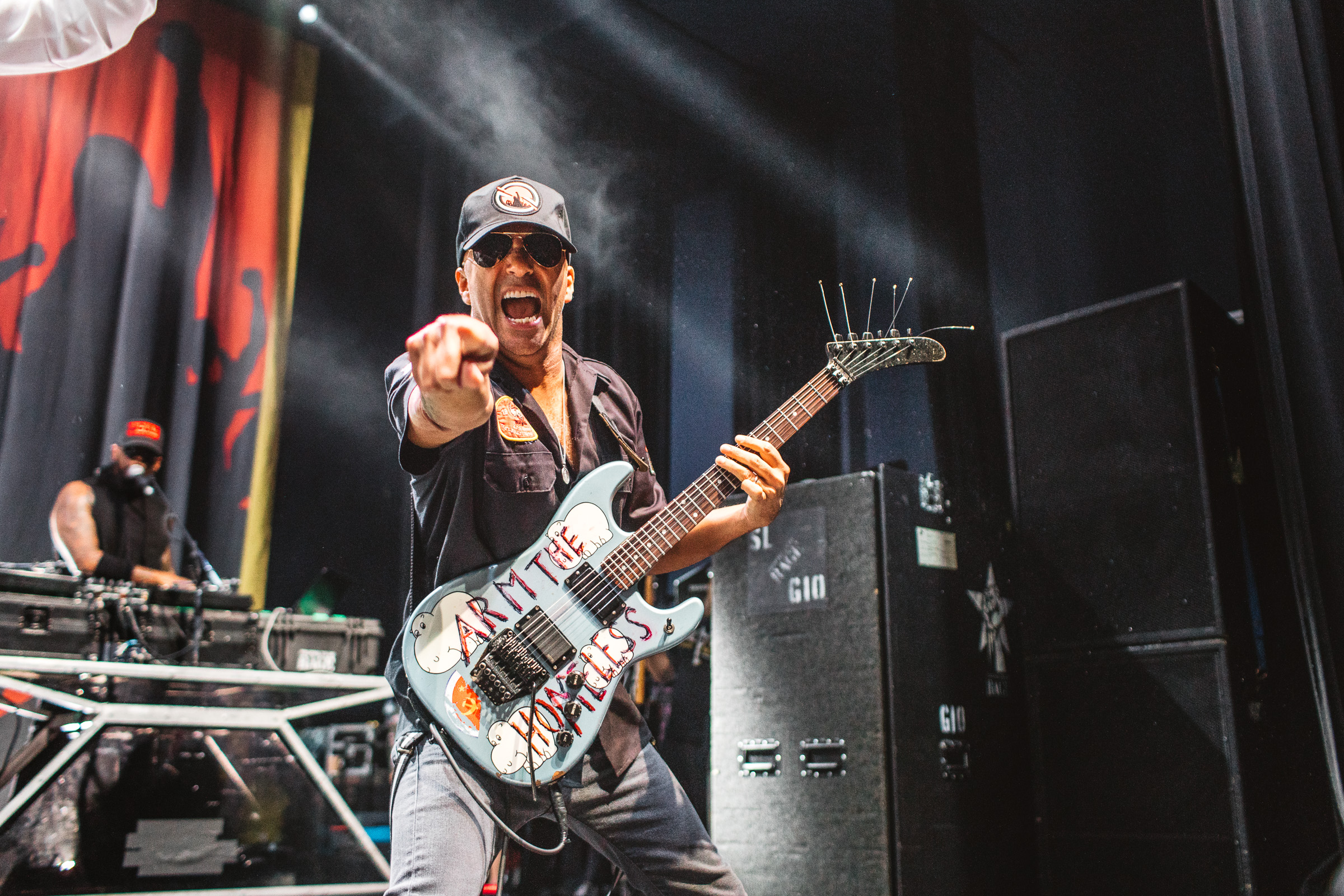 Tom Morello playing the Arm the Homeless guitar with Prophets of Rage, and pointing at the photographer