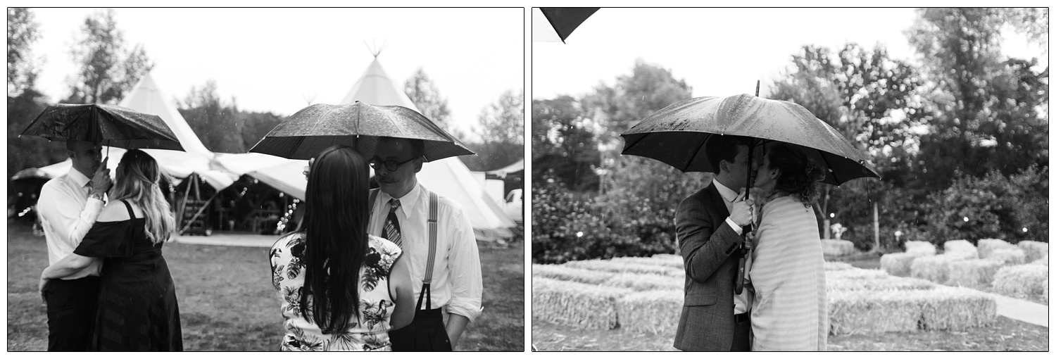 Couples under umbrellas in the rain at a wedding in Essex.