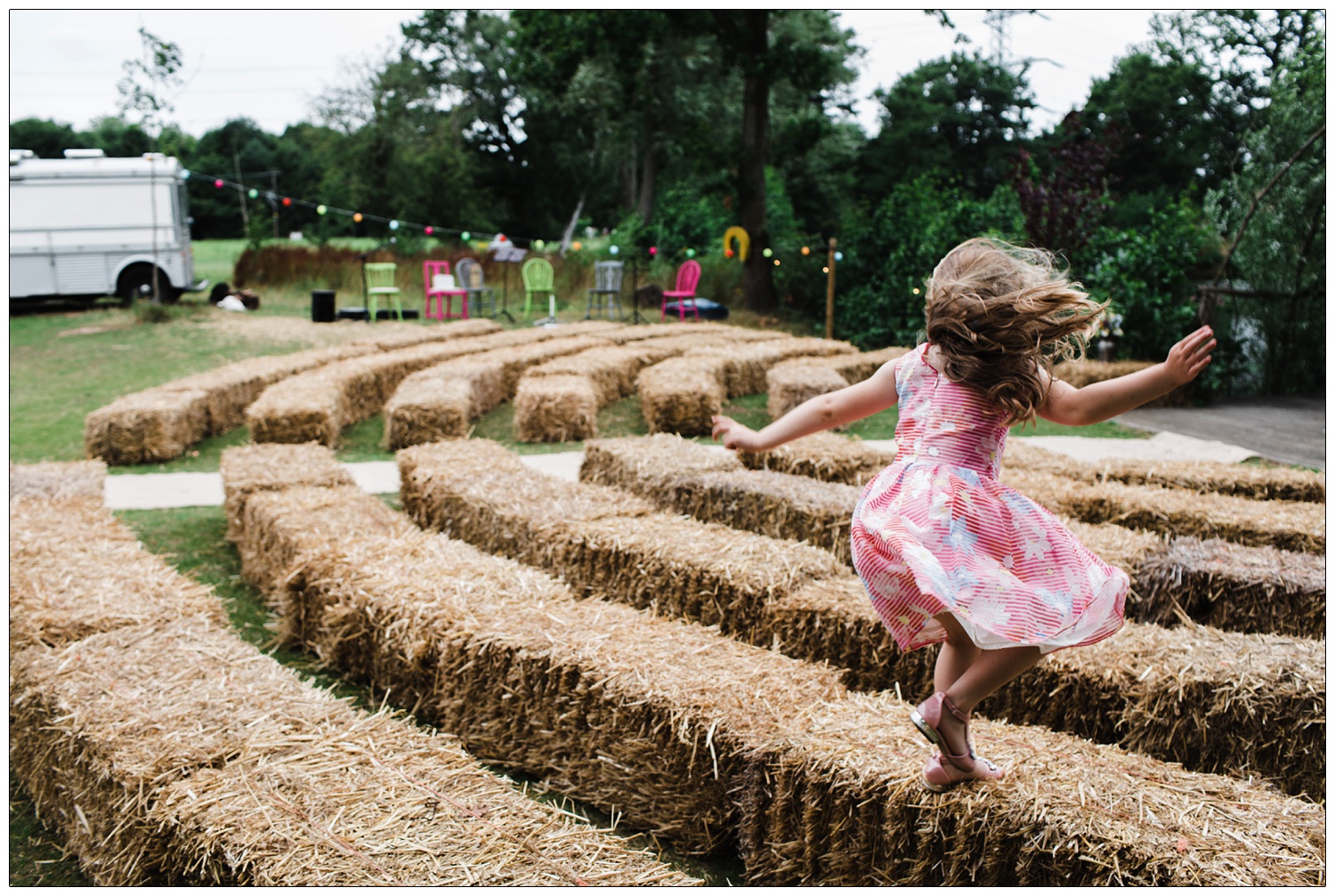 Girls jumping on hay bales.