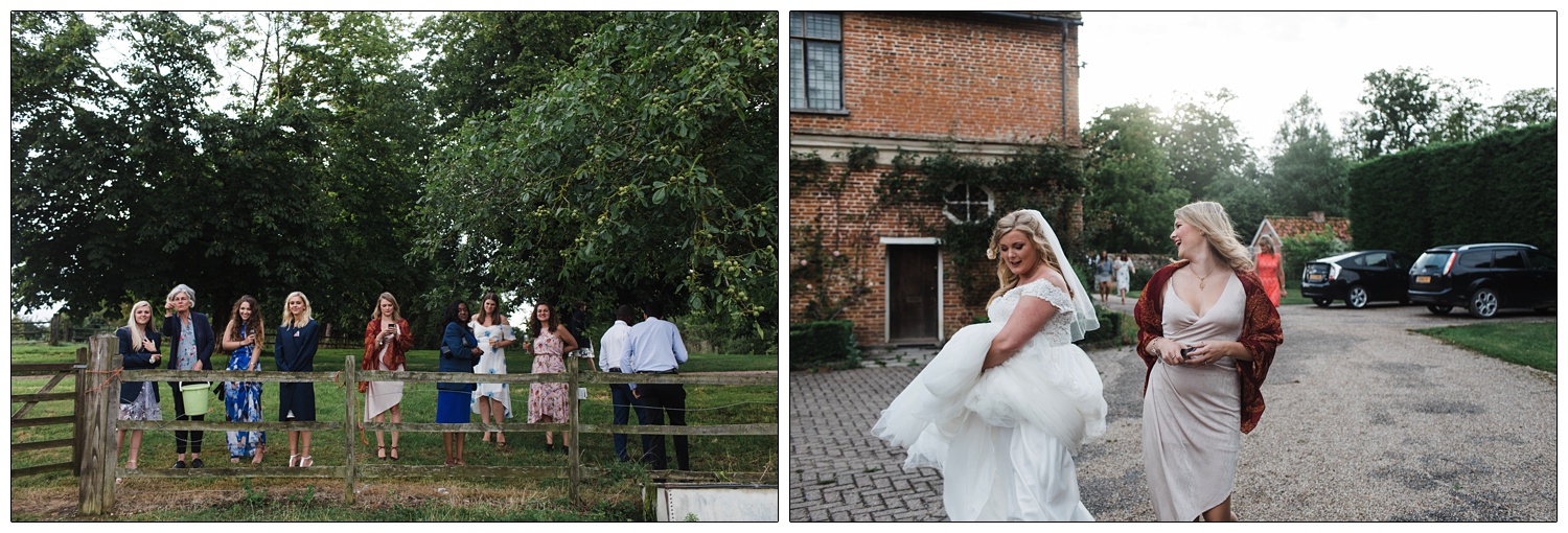 Wedding guests stood on a fence.