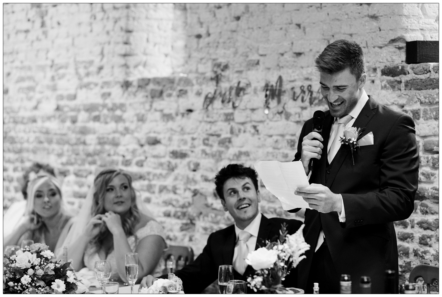 Black and white photograph of the best man's speech.