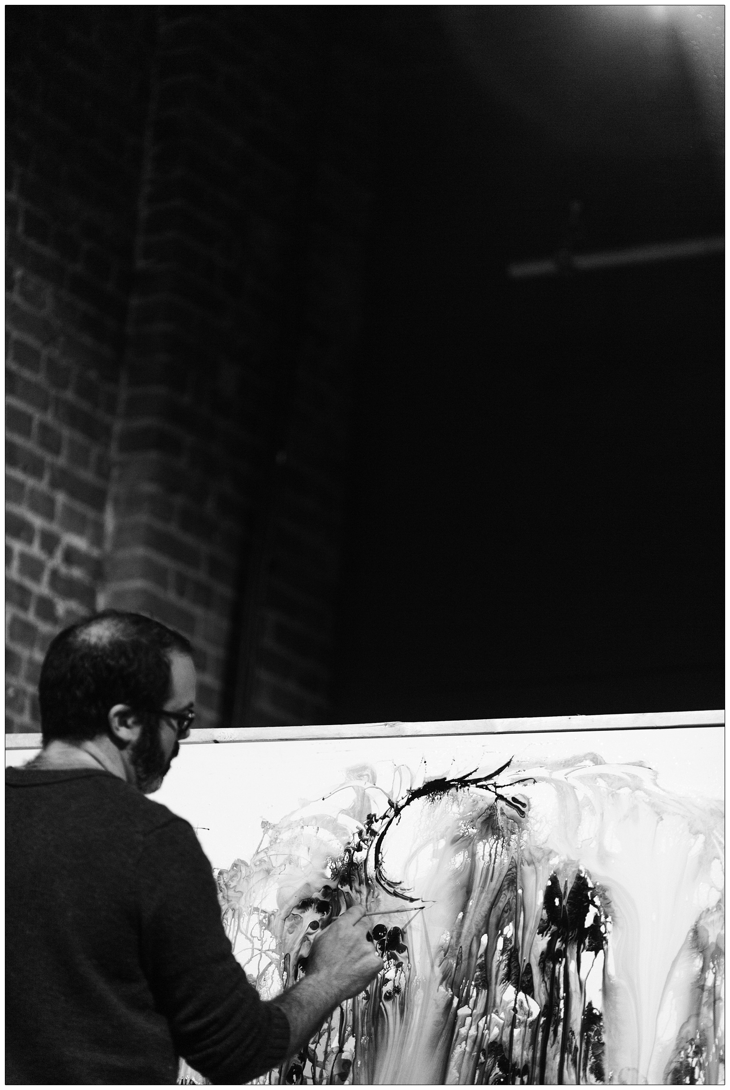 black and white photograph of Gregory Euclide painting at Lubomyr Melnyk concert