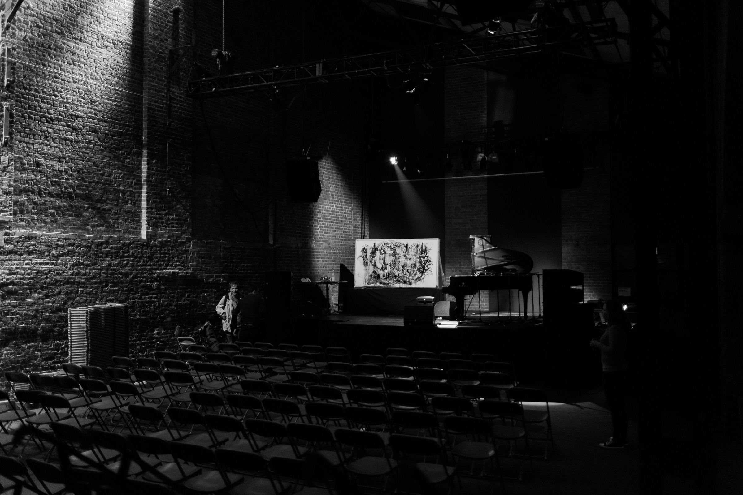 An almost empty venue, the Village Underground. Gregory Euclide's finished painting is in the light next to Lubomyr Melnyk's piano.
