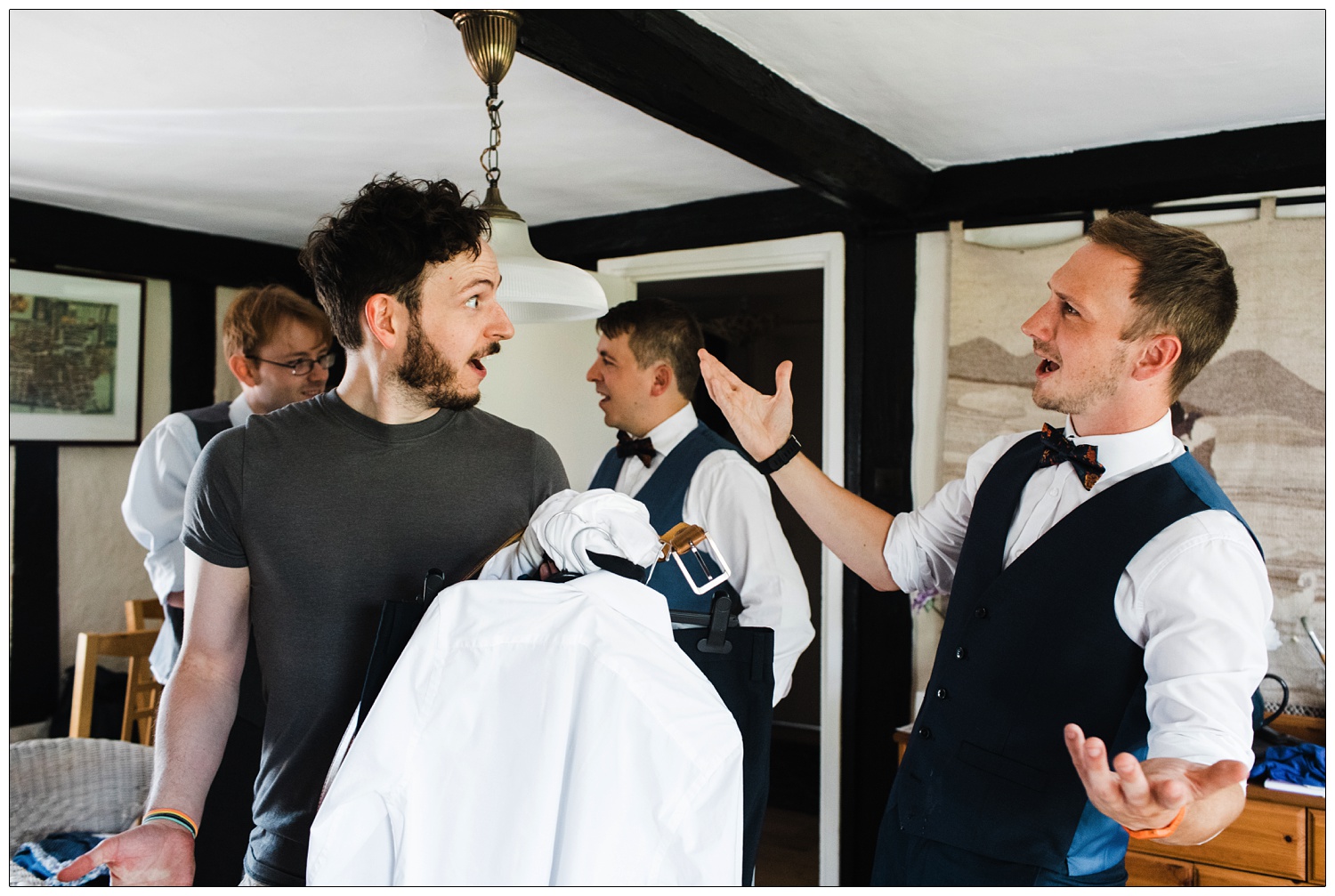 Groom and friends getting ready for a wedding at home.