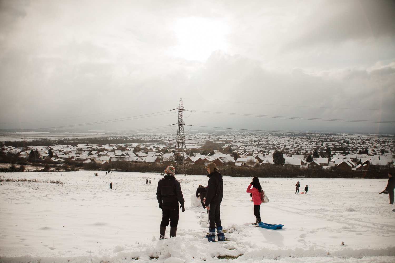 People enjoying the snowy scenery at Bushy Hill, also known locally as Radar Hill, with a view overlooking South Woodham Ferrers.