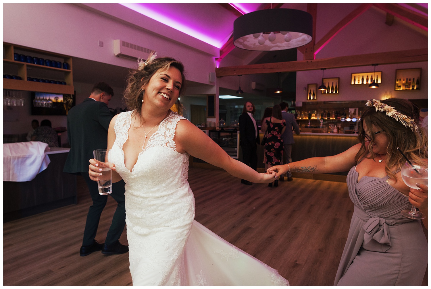 A bride dancing with her sister at the evening reception.