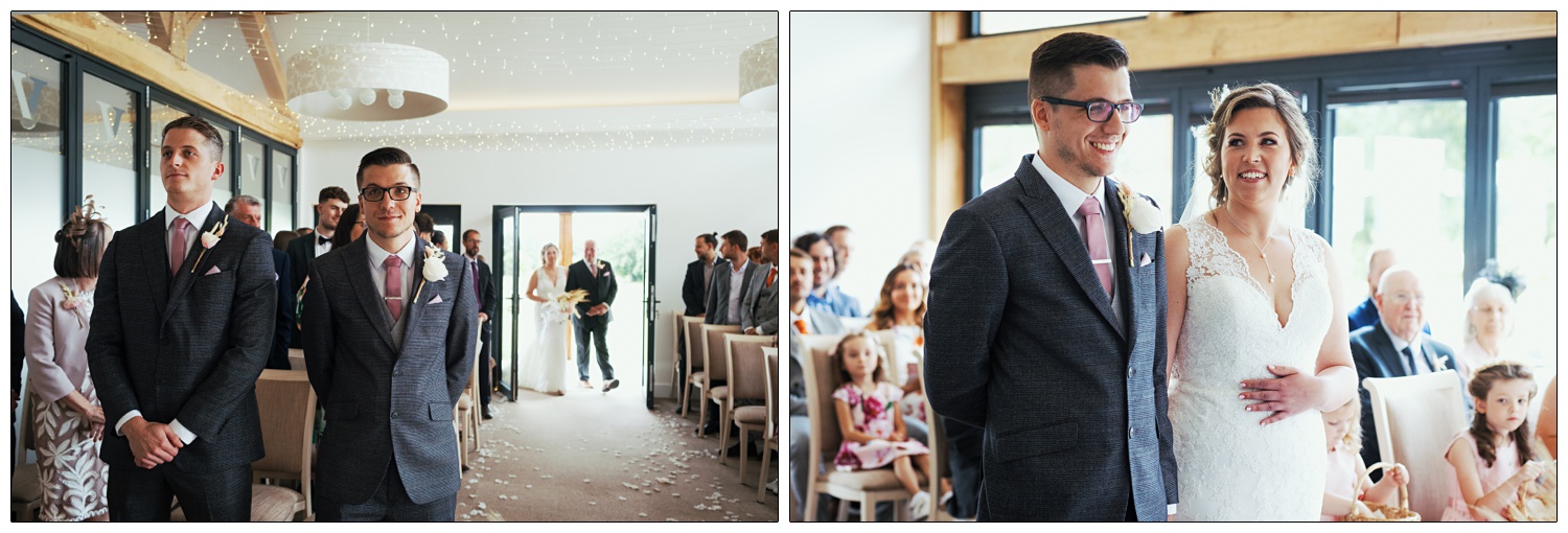 Bride enters the room with her dad. She looks at the groom and they smile at Fynn Valley Terrace.