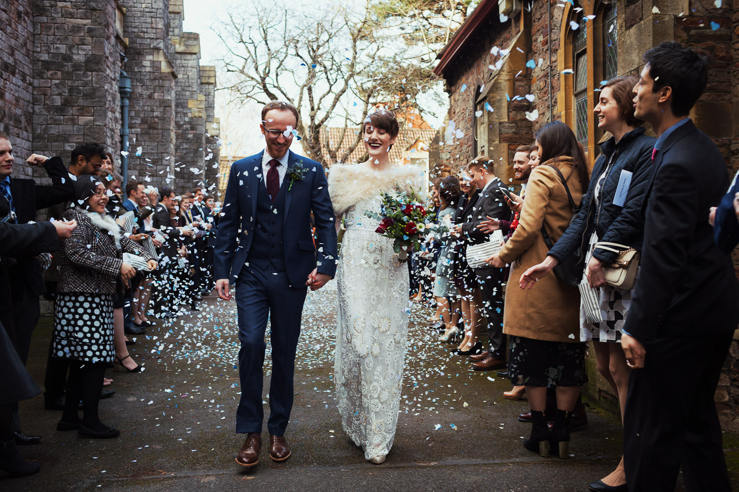 Confetti hearts falling on a man and woman after their wedding ceremony at St Alban's Church of Westbury Park Bristol wedding