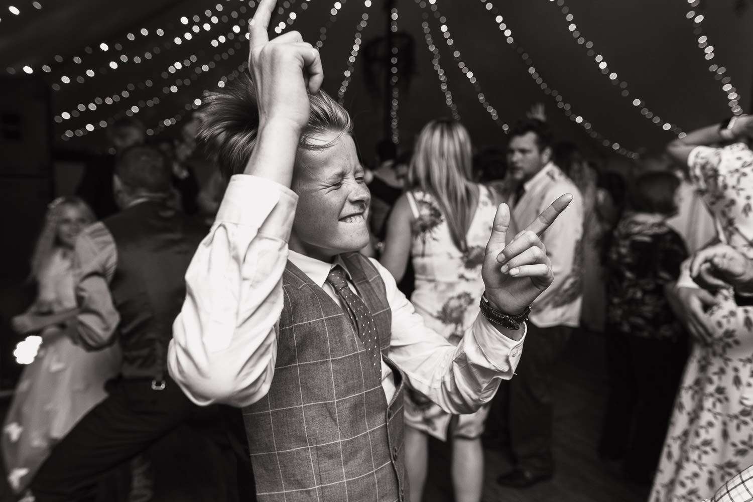 Boy dancing at wedding.