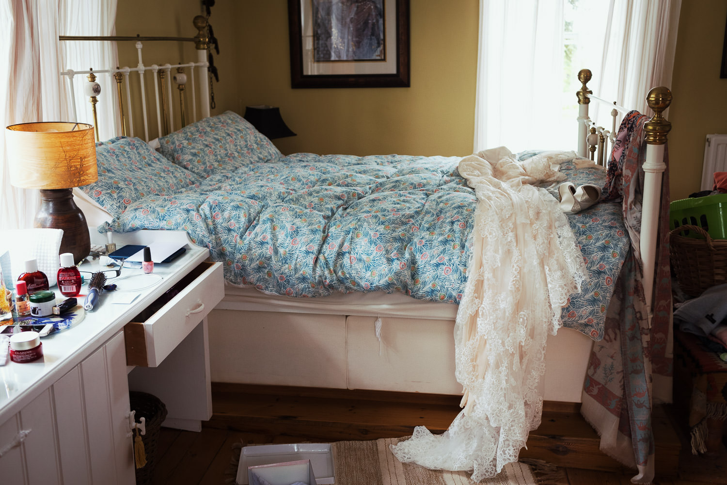 A wedding dress lying on a bed. Documentary style wedding photography in Great Totham, Maldon.