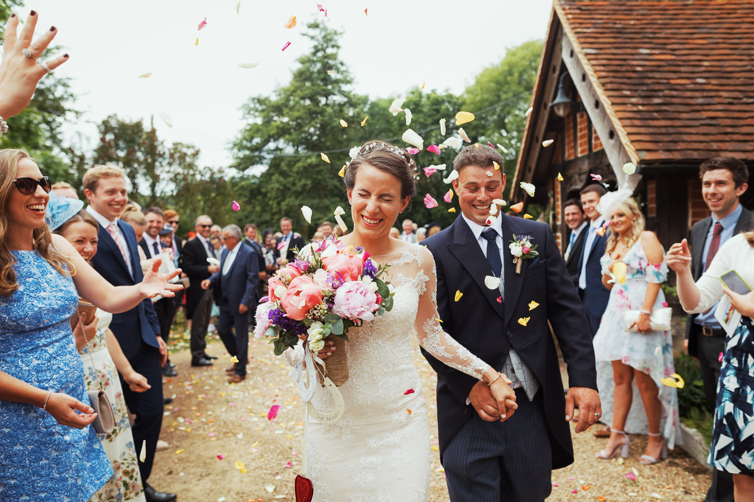 Outside St Peter's Church in Great Totham people through petals at a couple who just got married.