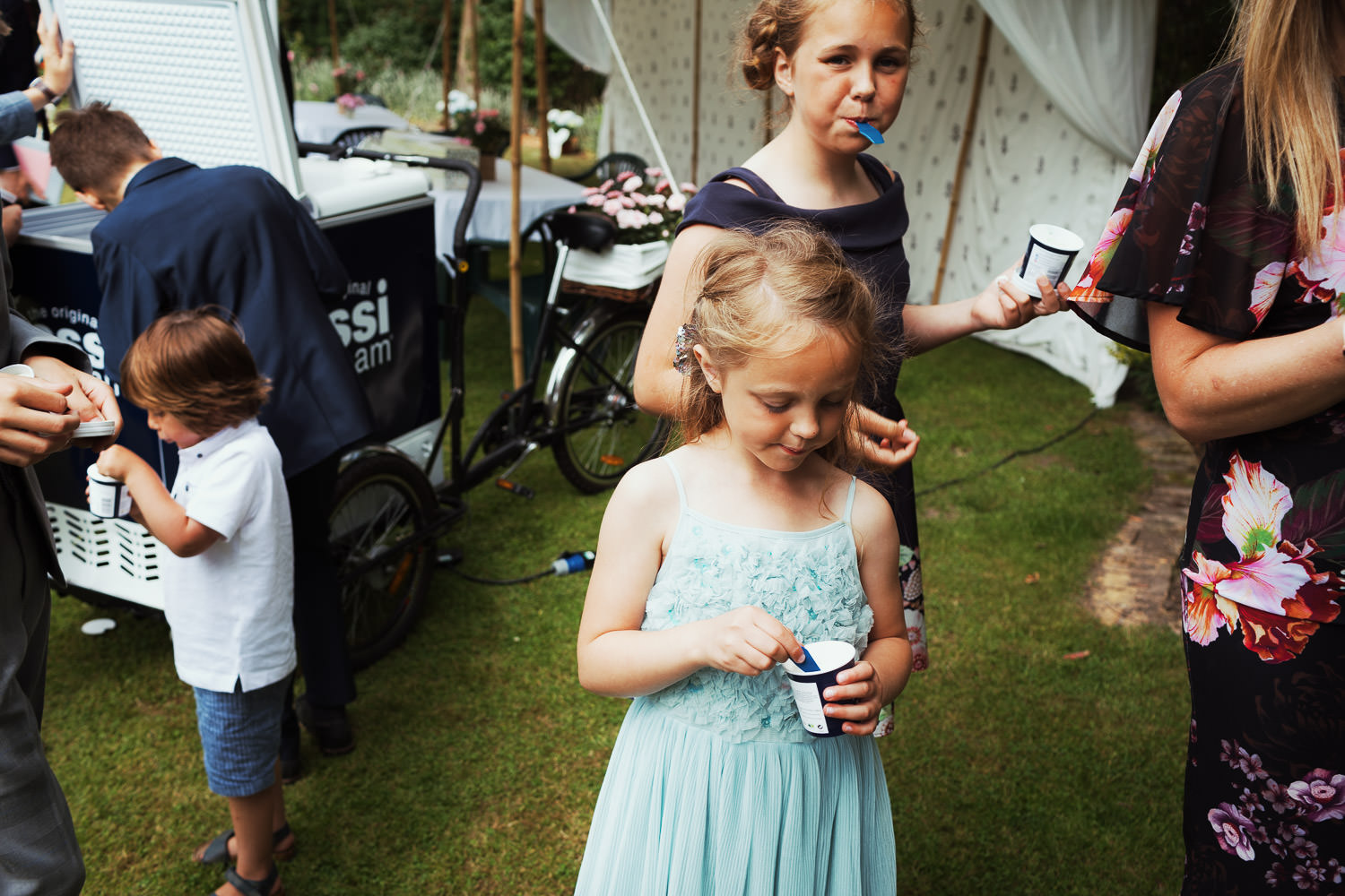 Children eating Rossi ice cream at a wedding near Maldon in Essex.