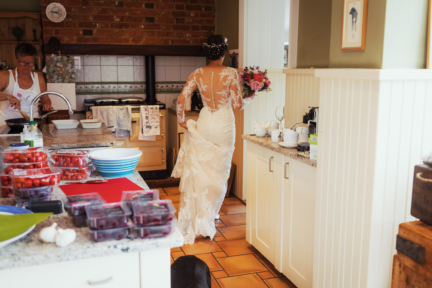 Bride walking through the kitchen.