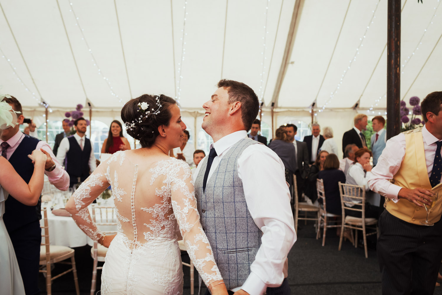 Bride and groom have their first dance with their friends and family
