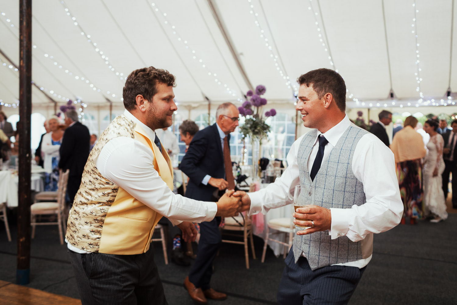 Two men dancing at a wedding.