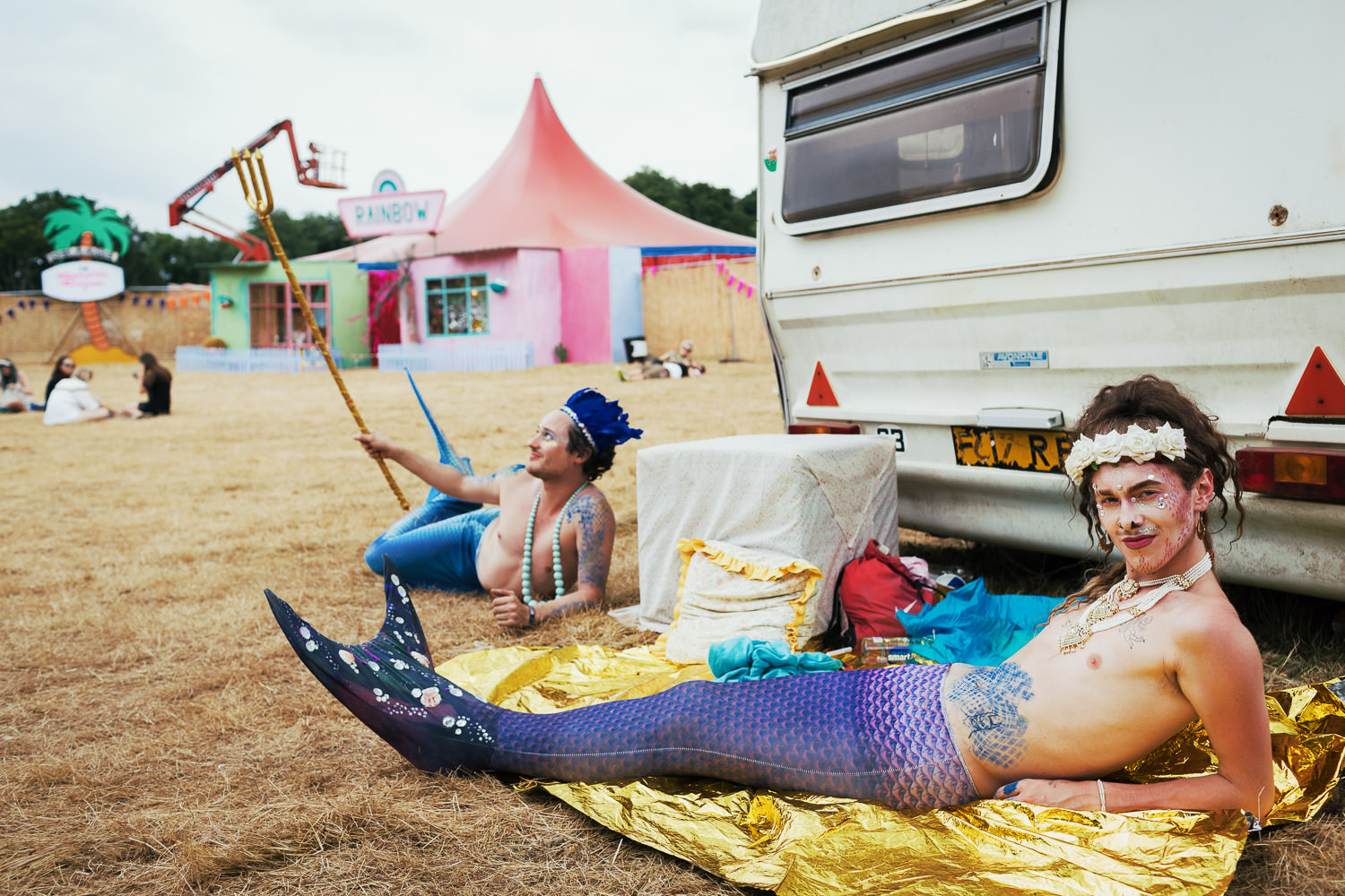 Charity Kase dressed as a mermaid lying by a caravan at Leefest Neverland.