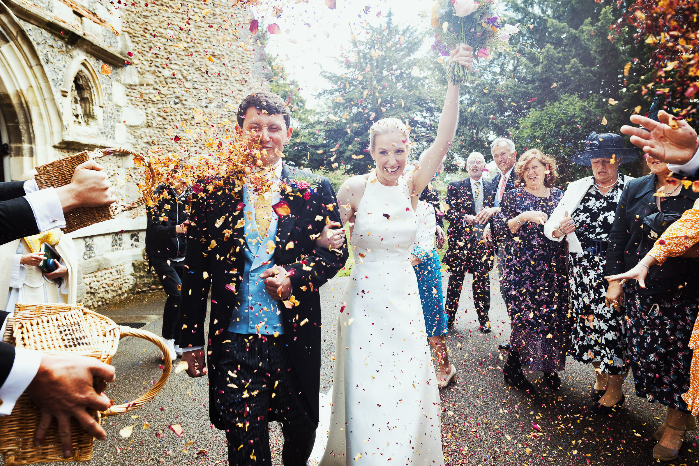 A basket of confetti thrown in the groom's face outside the church in Danbury after a wedding. Essex wedding photography.