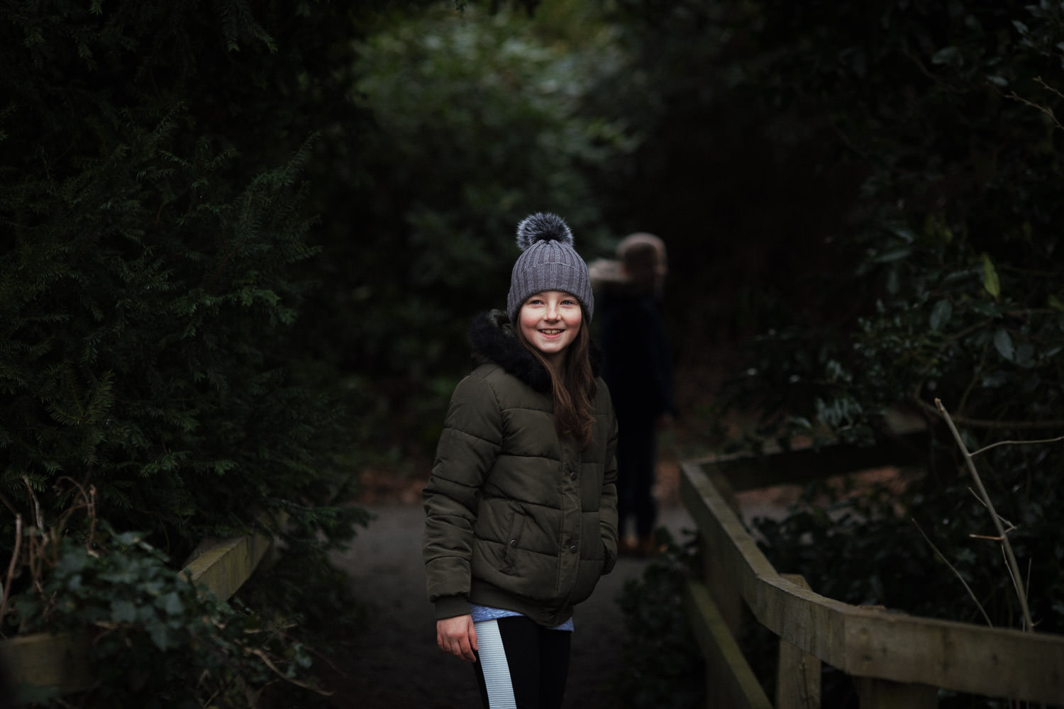 A girl in a coat and hat in Danbury woods near Chelmsford. On a family photoshoot by South Woodham Ferrers Essex photographer Tracy.
