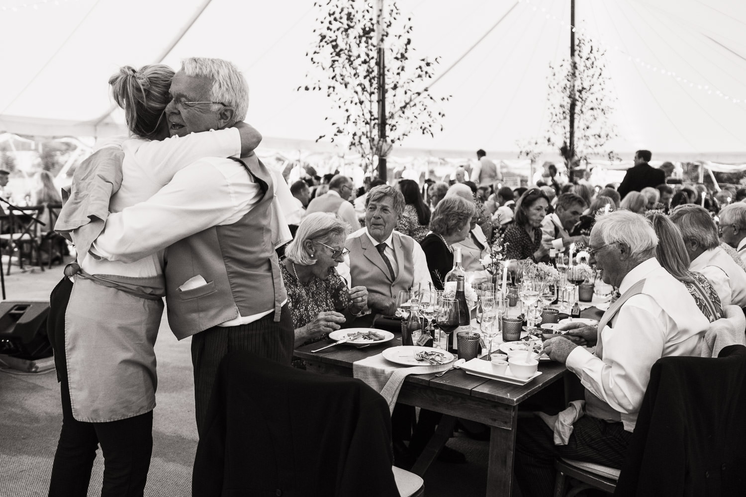 Member of the waiting staff from Anna Shutes hugs one of the guest during dinner.