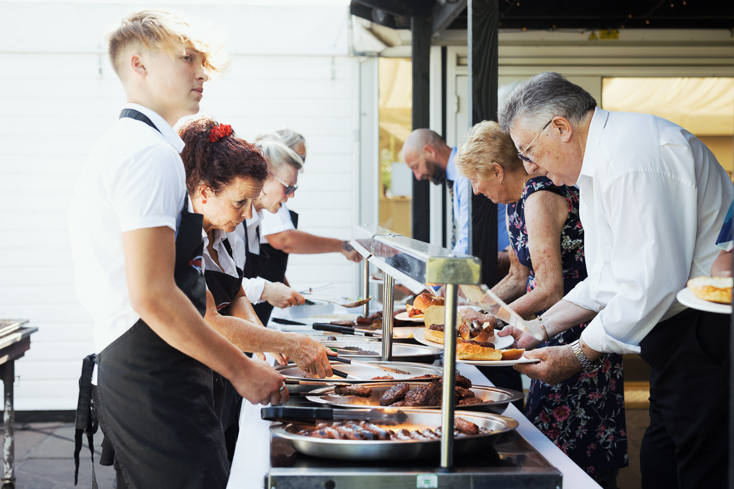 Valentine Cuisine caterers of South Woodham Ferrers serving food to guests at a High House wedding in Althorne.