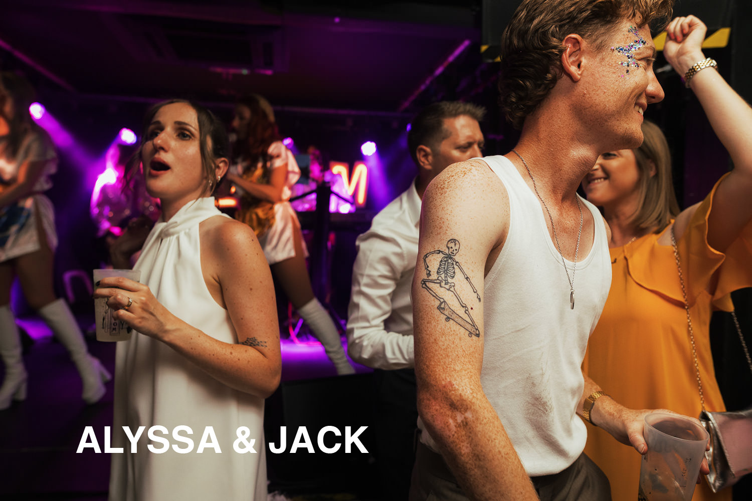 Bride and groom dancing to ABBA's Angels Tribute Band at The Boileroom wedding reception. Bride is wearing River Island White Feather Hem Shift Mini Dress.