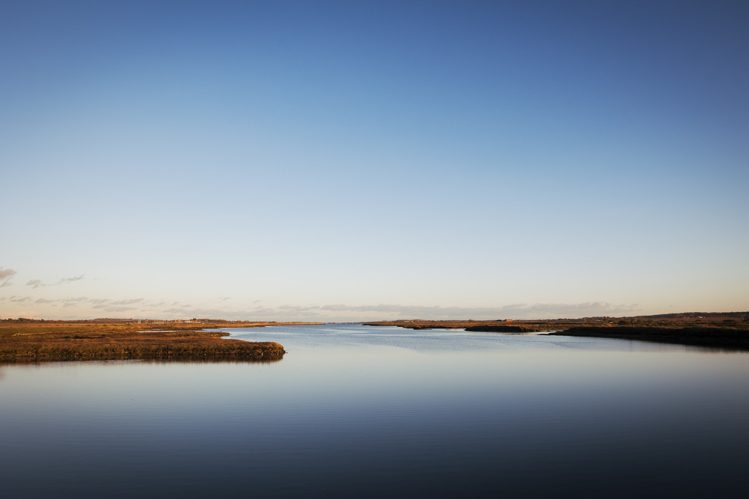 Clements Green Creek, off the River Crouch at Marsh Farm Country Park, is a Site of Special Scientific Interest located in South Woodham Ferrers. This photo, taken in November 2024 just before sunset, captures blue skies and golden light.