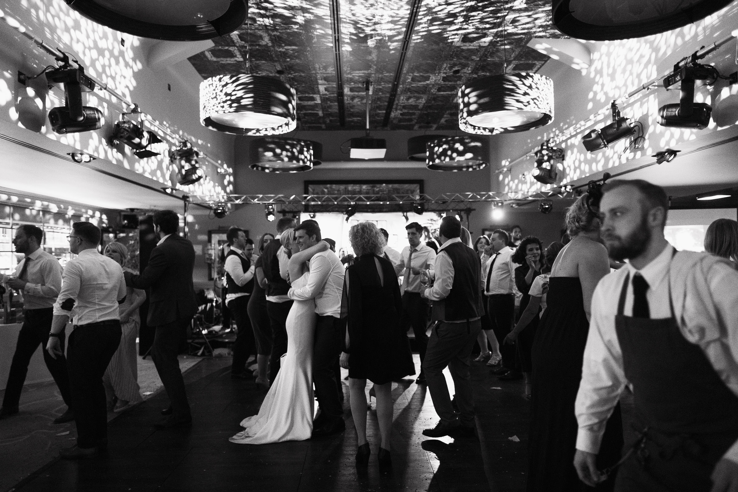 Newlyweds share their first dance at The Lion House, a popular wedding venue near Chelmsford, Essex. Guests and staff can be seen enjoying the celebration. CM3 3JA