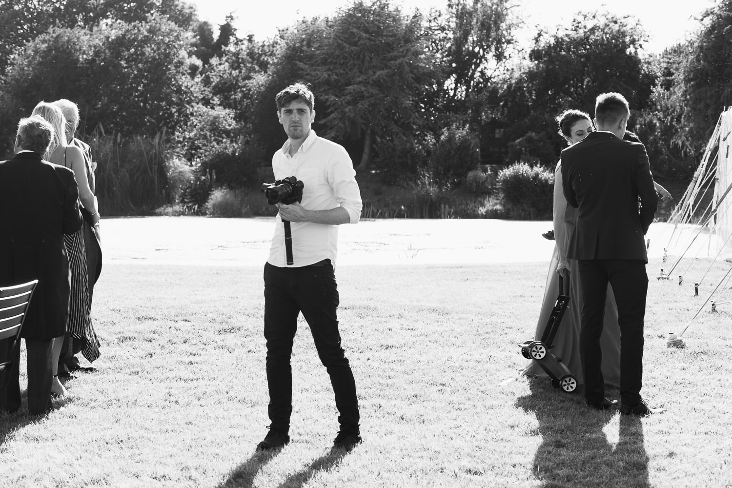 Philip Smith Visuals capturing moments at a garden wedding in Latchingdon, Essex near South Woodham Ferrers. He is holding his camera.