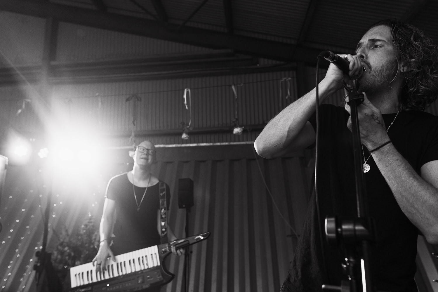 Indie rock covers band Alive playing at a wedding. Jonny Coote on keytar. An Essex wedding at home in a barn.