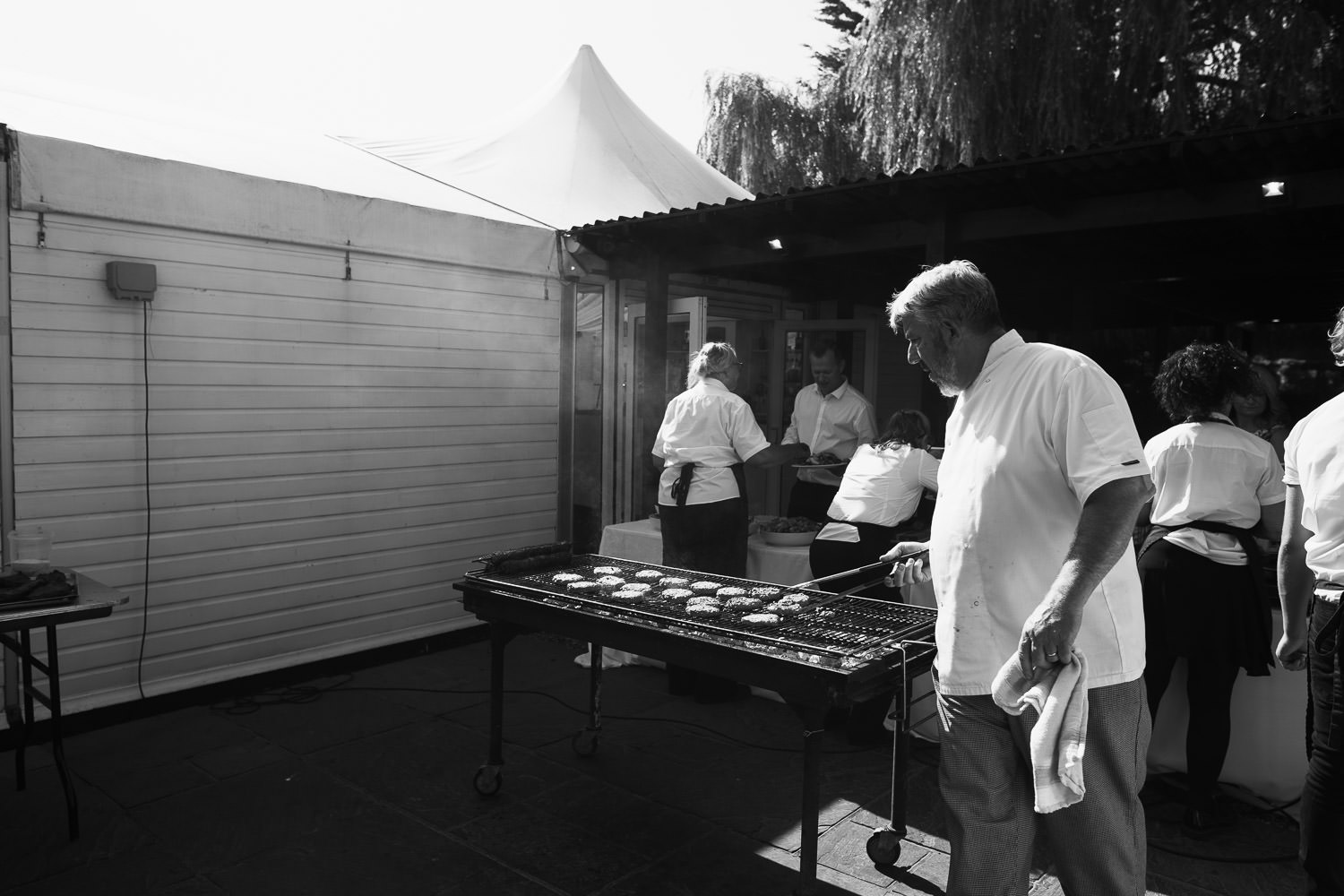 Tony Valentine of Valentine Cuisine in South Woodham Ferrers, manning the barbecue at a wedding at High House.