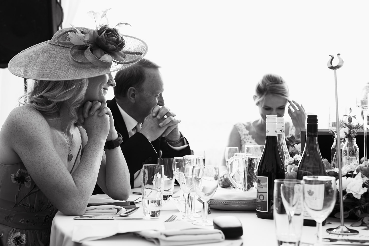 Black and white photograph of people on the top table during the speeches.