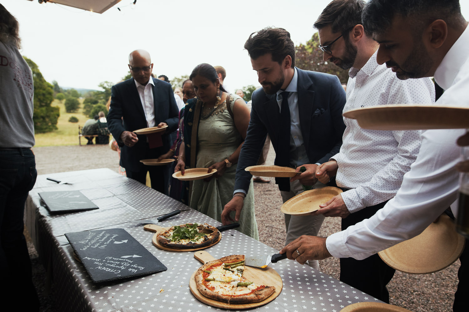 People queue and choosing pizza from The Old Dough Hook Pizza Company.