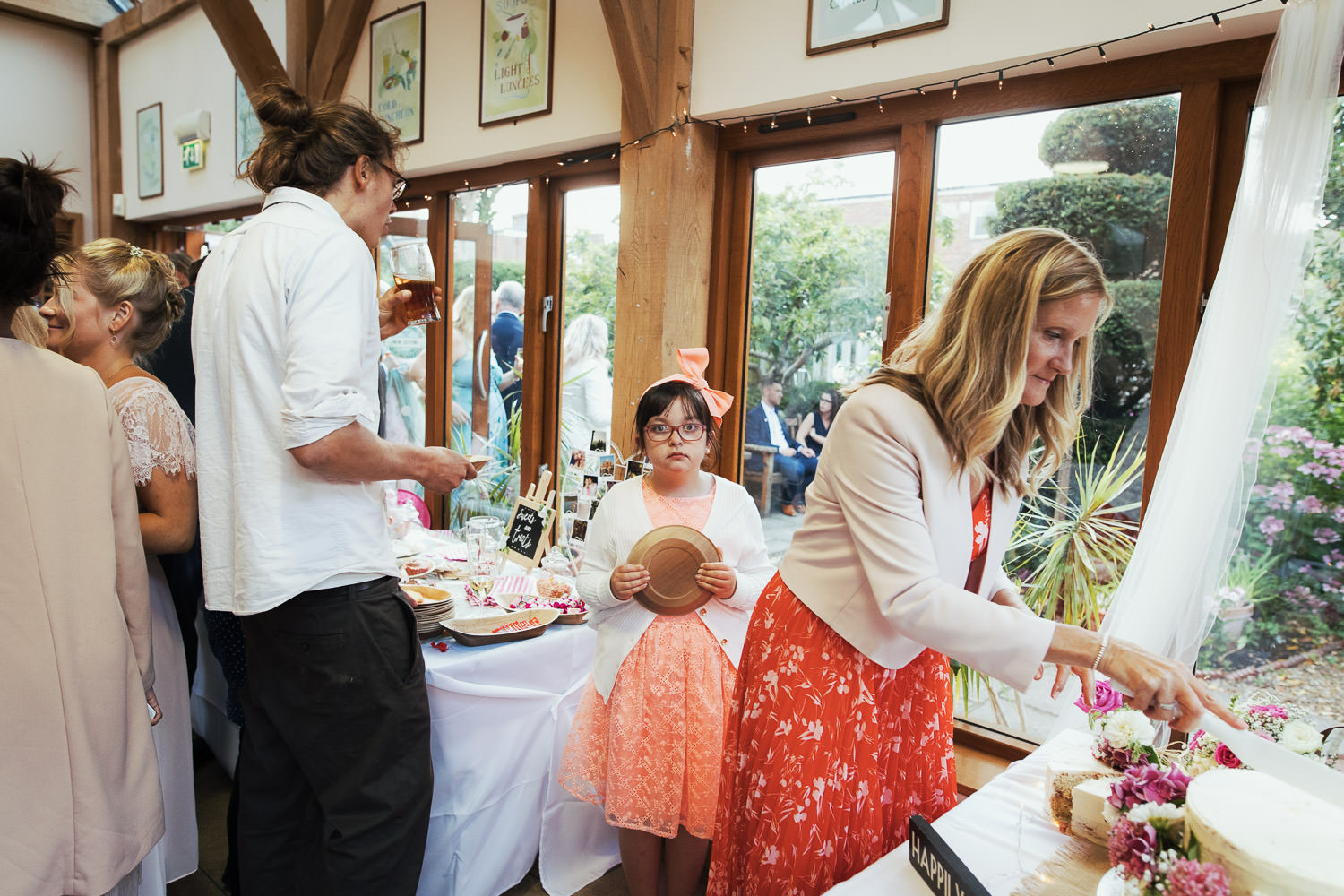 Girl holding a plate and looking at the camera. Waiting for cake.