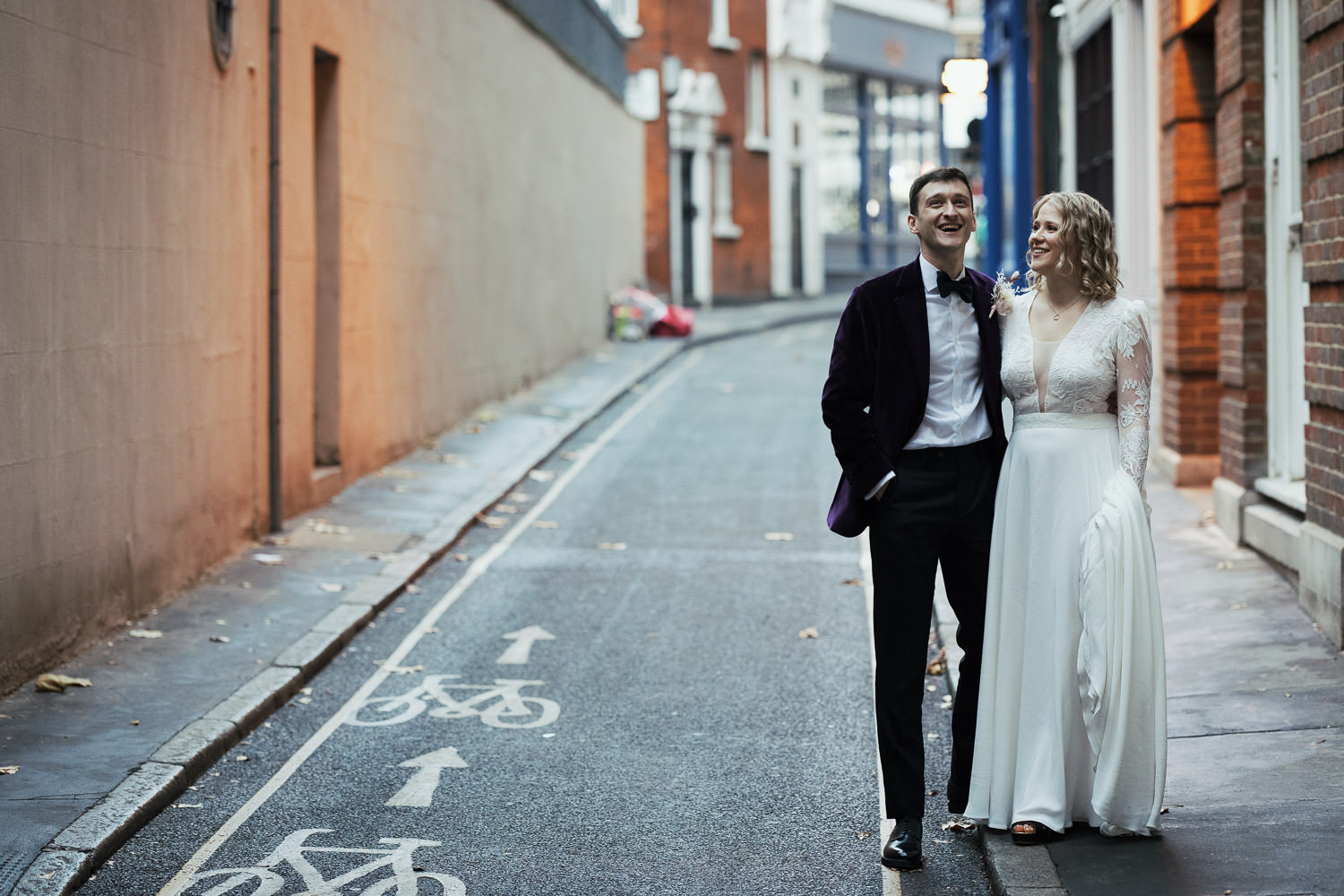 Relaxed wedding portraits of bride and groom on Bride Lane EC4Y. Humble Grape wine bar wedding venue.