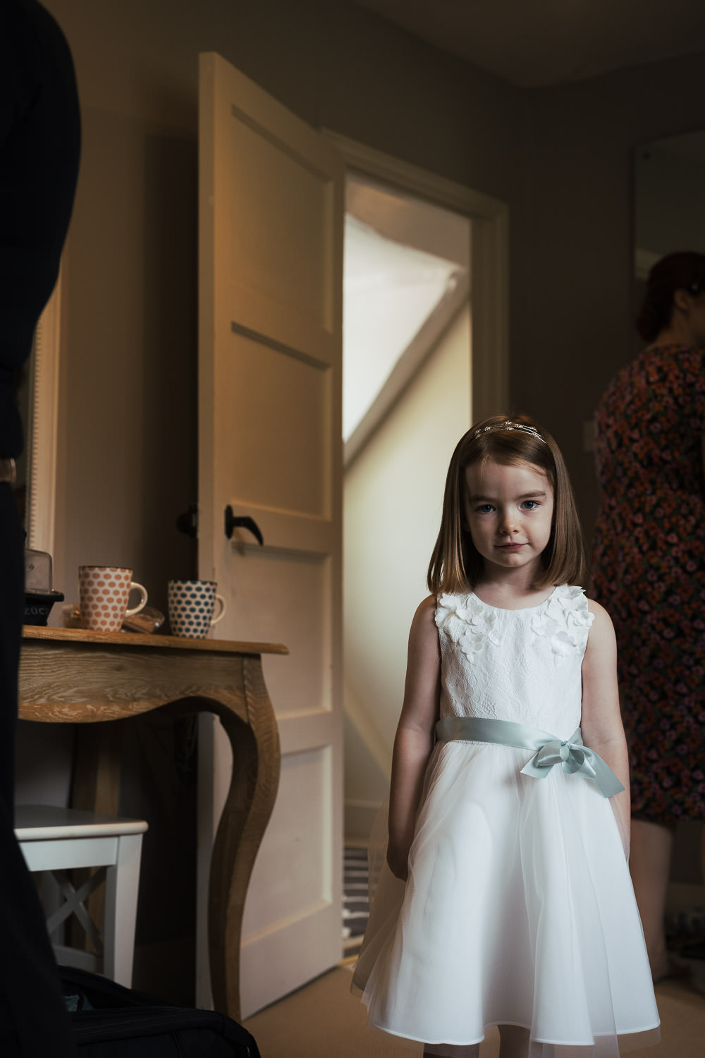 A flower girl in a white dress.