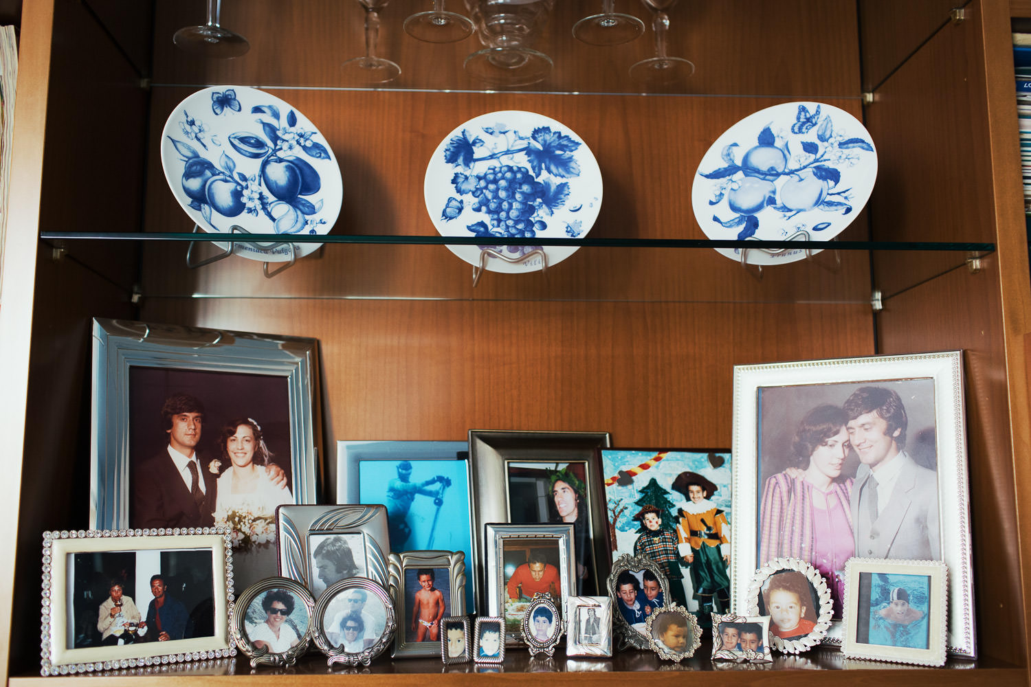 Family photos on the sideboard at the groom's family home.