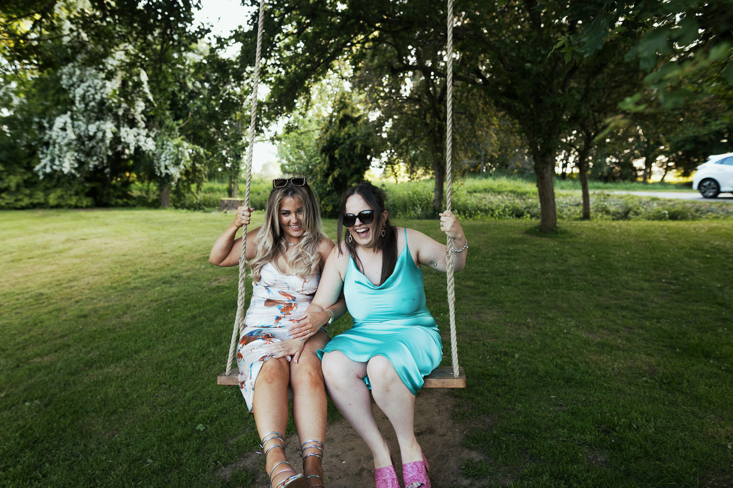 Two guests on a swing. During the evening at Houchins wedding venue in Essex.