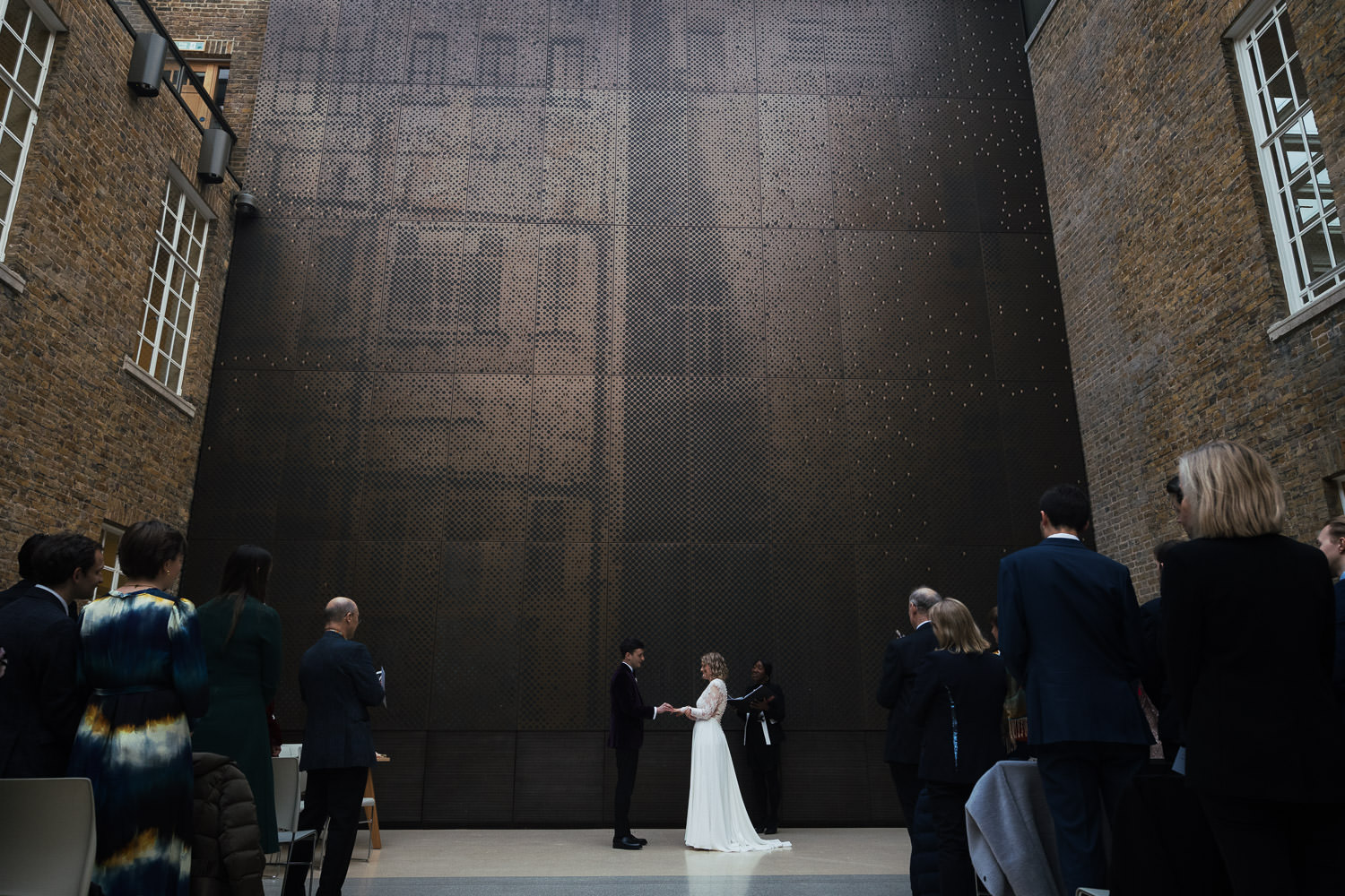 The view of the bride and groom exchanging rings from the back of the North Atria at Hackney Town Hall.