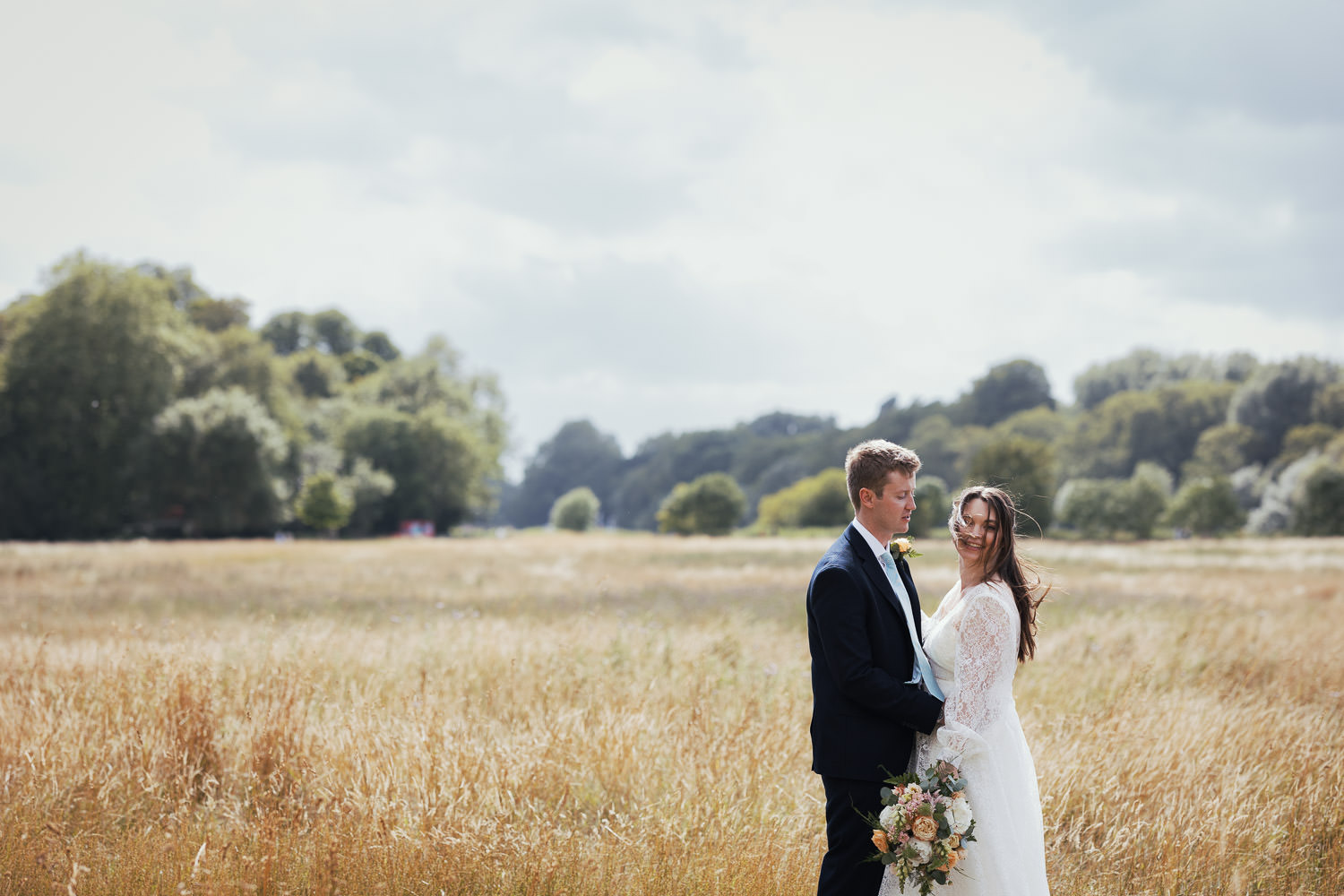 Newly weds on the path of the capital ring in the meadows at Petersham. Flowers by Rose & Mary, makeup and hair by Carla Viljoen.